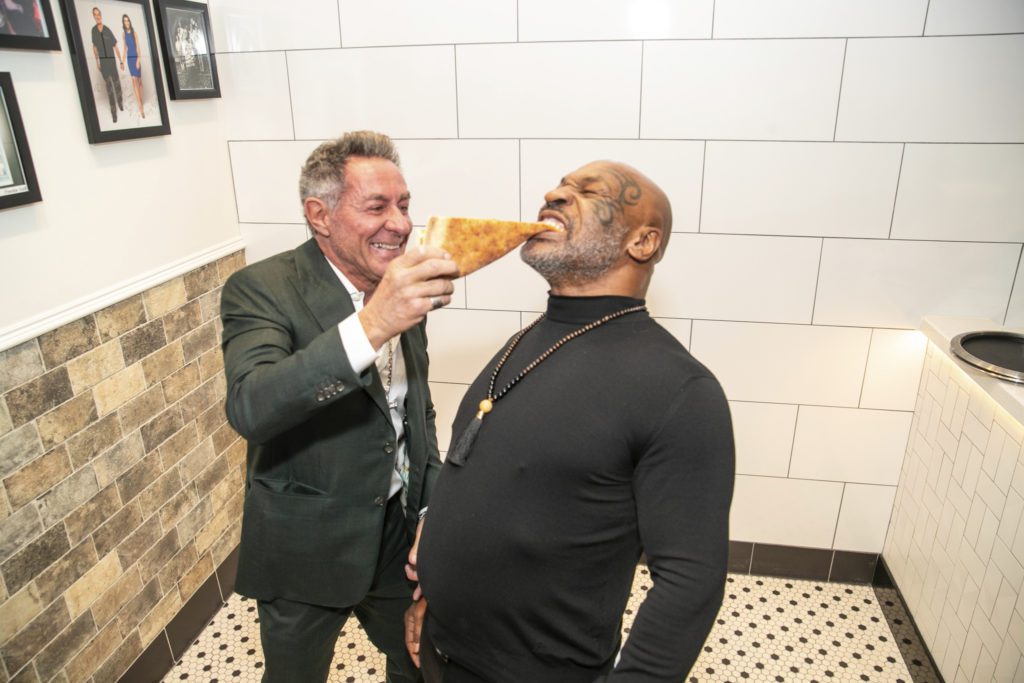 Resorts World Las Vegas LLC | Just a guy feeding Mike Tyson a slice of pizza